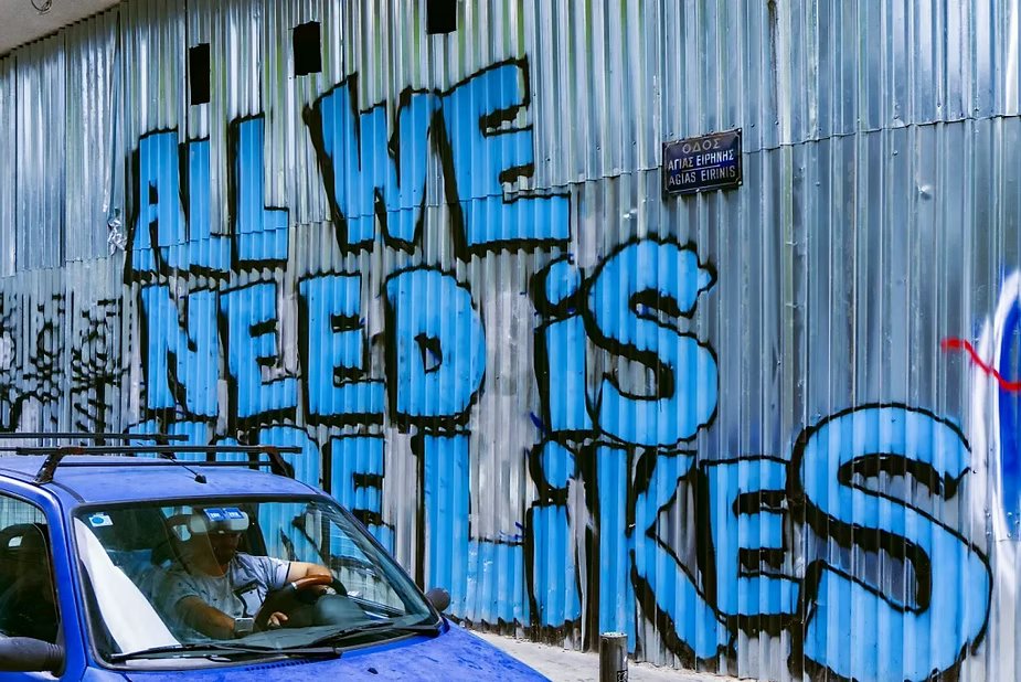 Grafite em um muro com a frase 'All we need is likes'